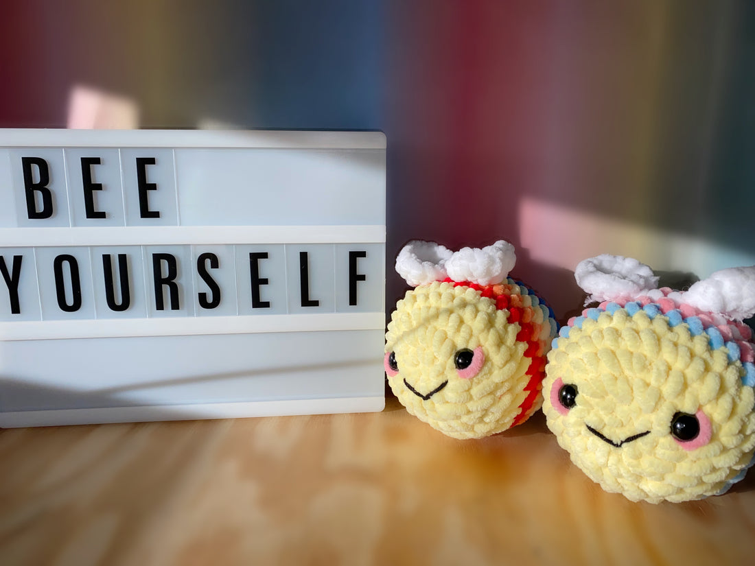 LGBTQ and Transgender Flag Bees next to a “Bee Yourself” sign 